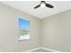 Bright, neutral bedroom features a window, a ceiling fan, and gray wood-look flooring at 6245 Alhambra Ave, North Port, FL 34291