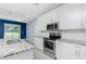 Bright kitchen features white cabinets, granite countertops, and stainless steel appliances at 6245 Alhambra Ave, North Port, FL 34291