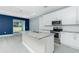 Open-concept kitchen with white cabinetry, granite countertops, and a stainless steel appliance suite at 6245 Alhambra Ave, North Port, FL 34291