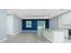 Spacious living area open to kitchen, featuring recessed lighting, gray floors, and natural light at 6245 Alhambra Ave, North Port, FL 34291