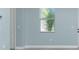 Inviting interior with light blue walls, white trim, and modern gray flooring at 6245 Alhambra Ave, North Port, FL 34291