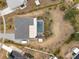 Aerial view of the property featuring a screened-in pool, gray roof, and a spacious backyard at 6531 Marius Rd, North Port, FL 34287