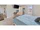 Carpeted bedroom showcases a desk, full-length mirror, and large bed with comfortable blue covers at 6531 Marius Rd, North Port, FL 34287