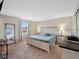 Well lit bedroom featuring neutral walls, carpet floors, and a large bed with side tables and lamps at 6531 Marius Rd, North Port, FL 34287
