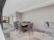 Outdoor dining area with seating for six, set against a backdrop of flagstone floors and pool views at 6531 Marius Rd, North Port, FL 34287