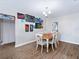Dining room with wood floors, light walls, and eclectic art leading to the home interior and adjacent rooms at 6531 Marius Rd, North Port, FL 34287