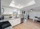 Bright kitchen with stainless steel appliances, granite countertops, and an adjacent dining area at 6531 Marius Rd, North Port, FL 34287