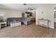Open-concept living and dining area with wood floors, comfortable seating, and ample space for entertaining guests at 6531 Marius Rd, North Port, FL 34287