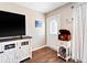 Inviting living room with wood floors, an entertainment center, and a charming entryway table at 6531 Marius Rd, North Port, FL 34287