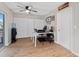 Well-lit office space featuring wood flooring, a ceiling fan, and ample closet space for storage at 6531 Marius Rd, North Port, FL 34287