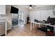 Open office space connecting to a screened-in patio, featuring wood floors, and a ceiling fan at 6531 Marius Rd, North Port, FL 34287