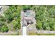 A serene aerial view of a charming home complete with a private pool nestled amongst the trees at 7135 Tropicaire Blvd, North Port, FL 34291
