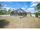 Expansive backyard featuring an in-ground pool and screened-in patio, ready for outdoor enjoyment at 7135 Tropicaire Blvd, North Port, FL 34291