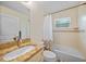 A bathroom features granite countertop, tub, shower, and a decorative window at 7135 Tropicaire Blvd, North Port, FL 34291