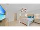 Bright and spacious bedroom with a ceiling fan and a large window with natural lighting at 7135 Tropicaire Blvd, North Port, FL 34291