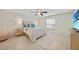 Well lit bedroom featuring a queen sized bed with modern decor and ensuite bathroom at 7135 Tropicaire Blvd, North Port, FL 34291