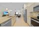 Open-concept kitchen showcasing granite counters, stainless appliances, and seamless flow to the living area at 7135 Tropicaire Blvd, North Port, FL 34291