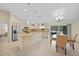 Open-concept kitchen featuring an island, stainless steel appliances, and a dining area at 7135 Tropicaire Blvd, North Port, FL 34291