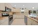 Modern kitchen featuring granite countertops, stainless steel appliances, and ample cabinet space at 7135 Tropicaire Blvd, North Port, FL 34291