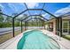 Sparkling in-ground pool enclosed by a screened cage, offering privacy and outdoor enjoyment at 7135 Tropicaire Blvd, North Port, FL 34291