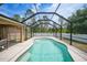 Sparkling in-ground pool enclosed by a screened cage, offering privacy and outdoor enjoyment at 7135 Tropicaire Blvd, North Port, FL 34291