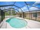 Sparkling in-ground pool enclosed by a screened cage, offering privacy and outdoor enjoyment at 7135 Tropicaire Blvd, North Port, FL 34291