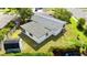 Aerial view of backyard with storage shed, privacy fence, and green grass at 815 Papaya Dr, Tampa, FL 33619