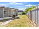 View of the backyard featuring a storage shed and a wooden fence at 815 Papaya Dr, Tampa, FL 33619