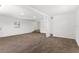 Open basement area with neutral carpet and access to stairs at 815 Papaya Dr, Tampa, FL 33619