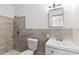 Modern bathroom featuring neutral wall tile, a new toilet, sink and mirror at 815 Papaya Dr, Tampa, FL 33619