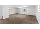 Large bedroom featuring neutral carpet, and two large windows for plenty of natural light at 815 Papaya Dr, Tampa, FL 33619
