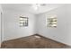 Bright bedroom with ample light, ceiling fan, and carpeted floor; perfect for relaxation at 815 Papaya Dr, Tampa, FL 33619