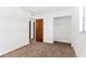 Bedroom featuring neutral carpet, and closet with wood door at 815 Papaya Dr, Tampa, FL 33619