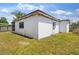 The exterior of this home shows a white block wall, small windows, and grass at 815 Papaya Dr, Tampa, FL 33619