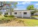 Charming single-story home with a well-maintained lawn and a covered front porch at 815 Papaya Dr, Tampa, FL 33619