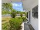 Inviting covered entry with decorative ironwork and vibrant landscaping details at 815 Papaya Dr, Tampa, FL 33619