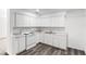 Bright kitchen featuring white cabinets, marbled countertops, and modern appliances at 815 Papaya Dr, Tampa, FL 33619