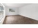 Bright living area featuring carpeted floors and a large window for natural light at 815 Papaya Dr, Tampa, FL 33619