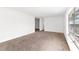 Expansive living room with neutral carpet and a glimpse into adjoining spaces at 815 Papaya Dr, Tampa, FL 33619