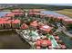 Aerial shot of community featuring red tile roofs, pools, palm trees, and lake views at 99 Vivante Blvd # 311, Punta Gorda, FL 33950