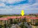 Beautiful aerial view of condos with red tile roofs near a body of water with a bright blue sky at 99 Vivante Blvd # 311, Punta Gorda, FL 33950