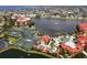Beautiful aerial view showcases the tennis courts and pools, nestled beside a serene lake at 99 Vivante Blvd # 311, Punta Gorda, FL 33950
