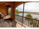 Spacious balcony with lake views, seating area, and a ceiling fan at 99 Vivante Blvd # 311, Punta Gorda, FL 33950