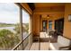 Relaxing screened balcony with seating area overlooking the lake and palm trees at 99 Vivante Blvd # 311, Punta Gorda, FL 33950