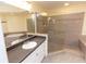 Spacious bathroom with glass shower, tub, and sink with granite countertop at 99 Vivante Blvd # 311, Punta Gorda, FL 33950