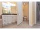 Well-lit bathroom with a vanity and tiled floor, with a half-open door to a toilet at 99 Vivante Blvd # 311, Punta Gorda, FL 33950
