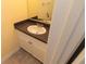 A well-lit bathroom featuring a granite vanity with a standard mirror at 99 Vivante Blvd # 311, Punta Gorda, FL 33950