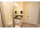 A bright bathroom with a granite vanity, large mirror, and towel rack at 99 Vivante Blvd # 311, Punta Gorda, FL 33950