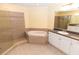 Elegant bathroom featuring a large soaking tub, separate shower, and vanity at 99 Vivante Blvd # 311, Punta Gorda, FL 33950
