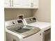 Bright laundry room featuring white cabinets, washer, and dryer for added convenience at 99 Vivante Blvd # 311, Punta Gorda, FL 33950